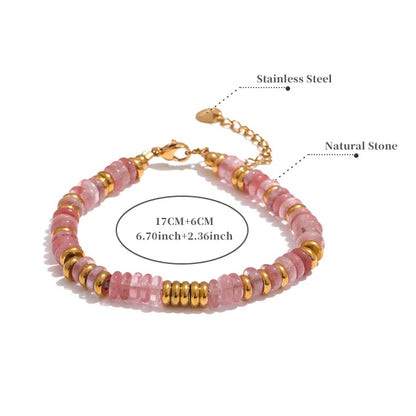 Bracelet with pink beads and gold accents on a white background