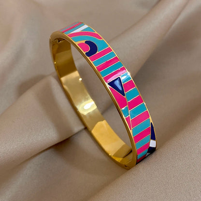 Colourful patterned bangle on a beige fabric background