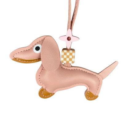 Pink dachshund-shaped keychain with a checkered bead on a white background