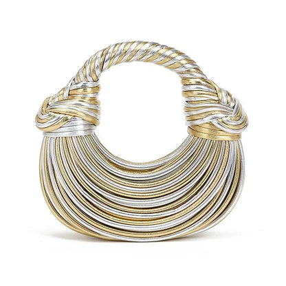 Gold and silver crescent shape handbag on a white background