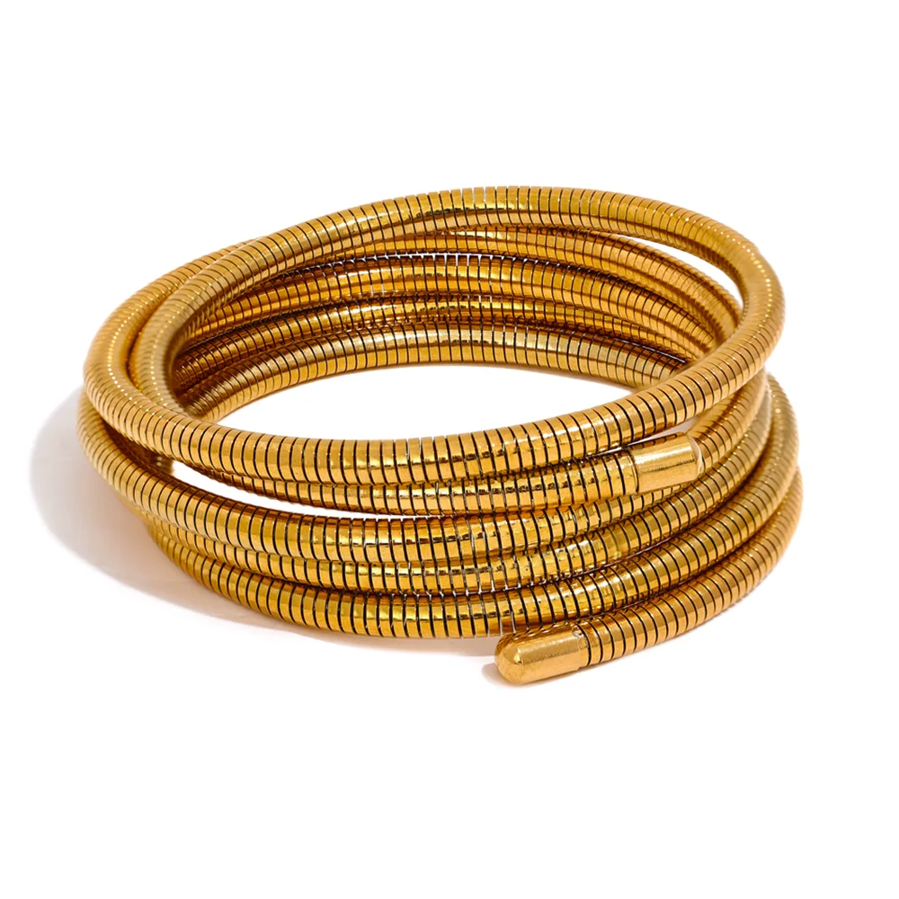 Gold bracelet with a textured pattern on a white background