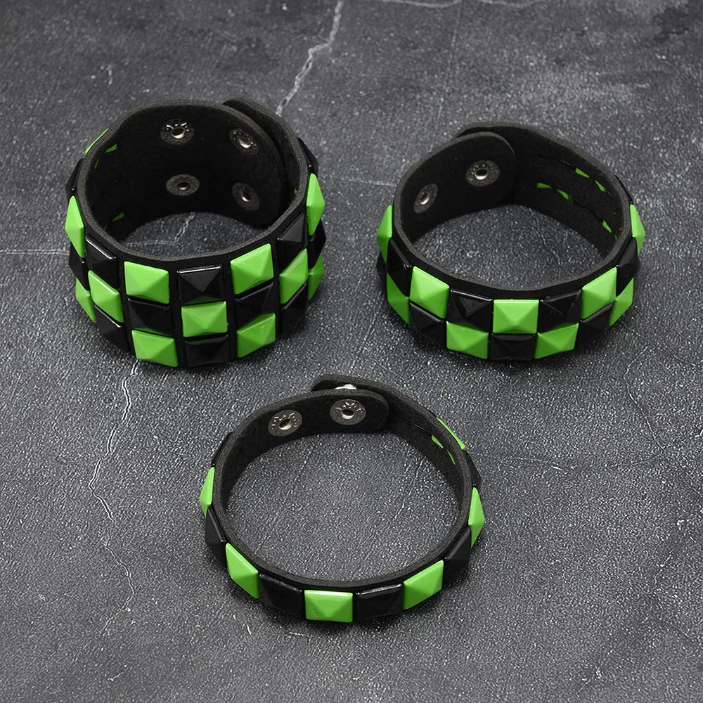 Three black and green checkered bracelets on a grey surface