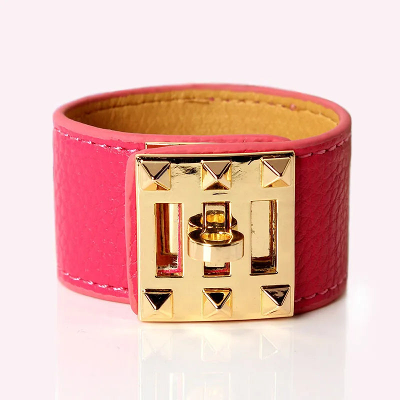 Pink leather bracelet with a gold clasp on a white background