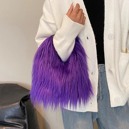 Person holding a purple fluffy bag with a neutral background