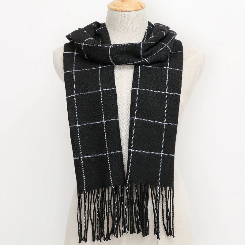 Black and white plaid scarf with fringes on a mannequin against a white background