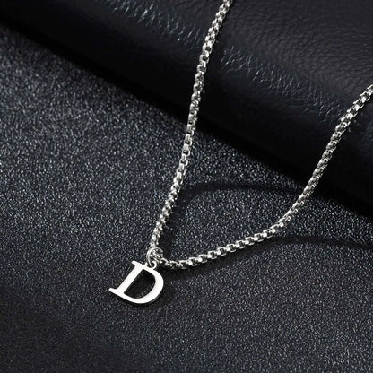 Silver necklace with a 'D' pendant on a black textured background