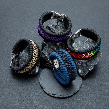 Five woven bracelets with different colour patterns on a dark grey background