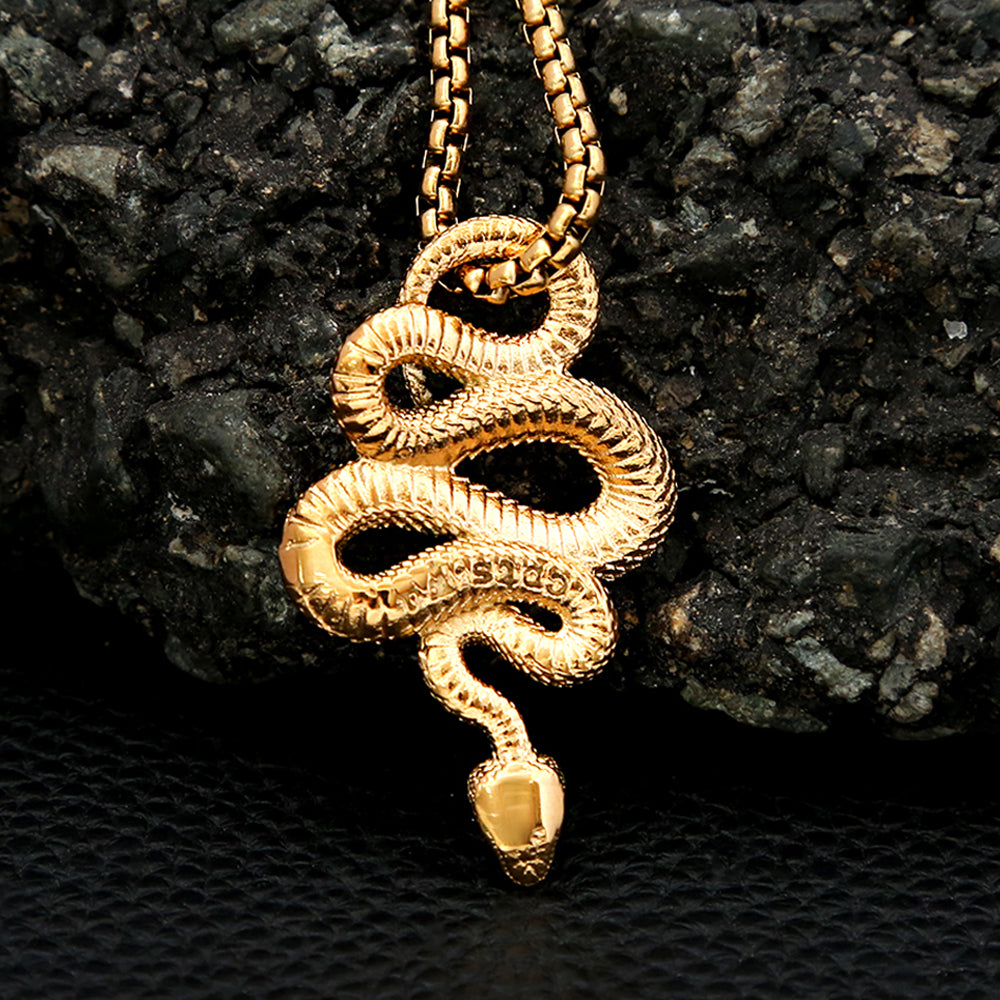 Gold snake pendant necklace on a dark textured background
