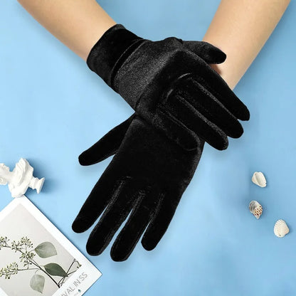 Black gloves on a person's hands with a light blue background