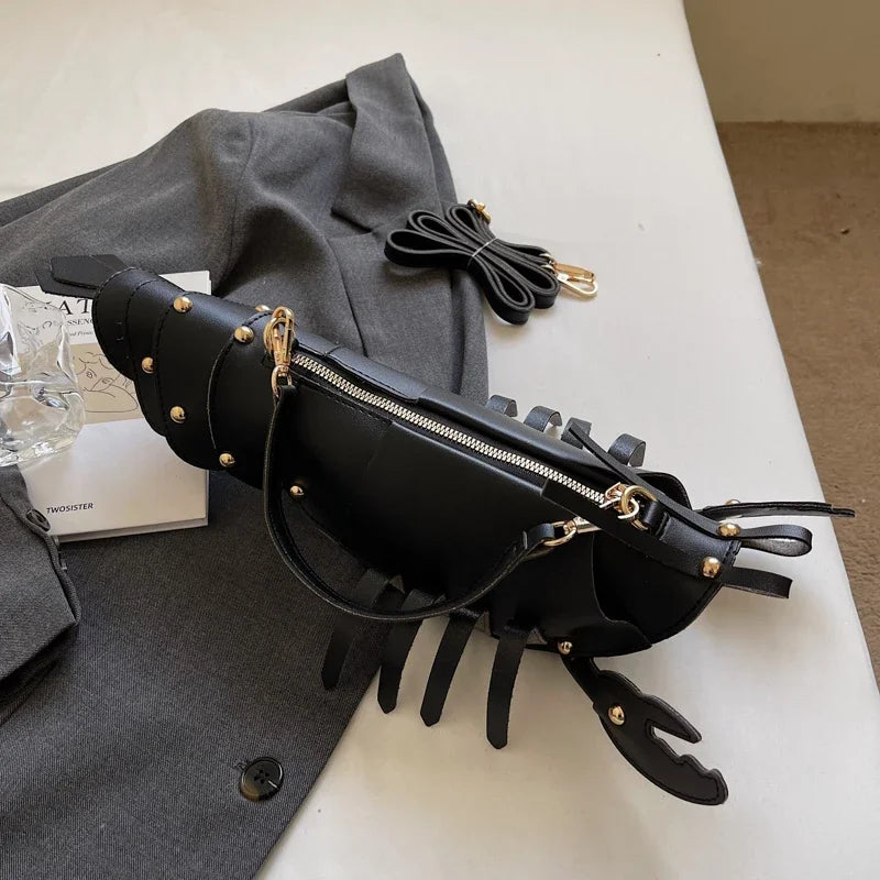 Black leather bag with gold accents on a white surface