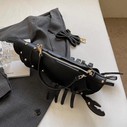 Black leather bag with gold accents on a white surface