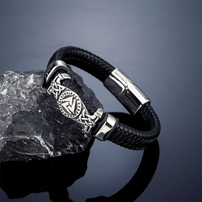 Black braided leather bracelet with silver clasp on a dark grey background