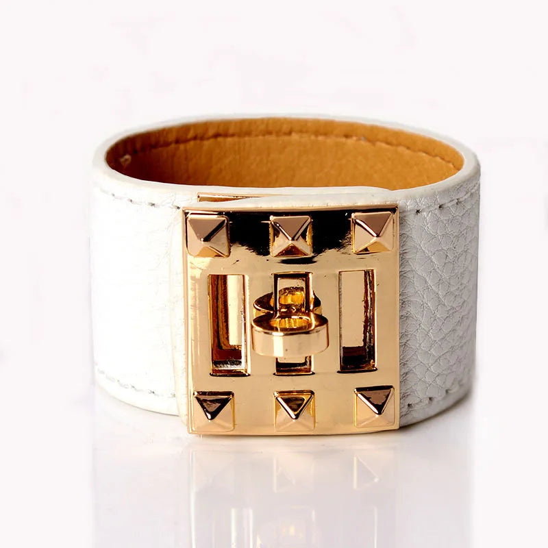 White leather bracelet with gold geometric design on a white background