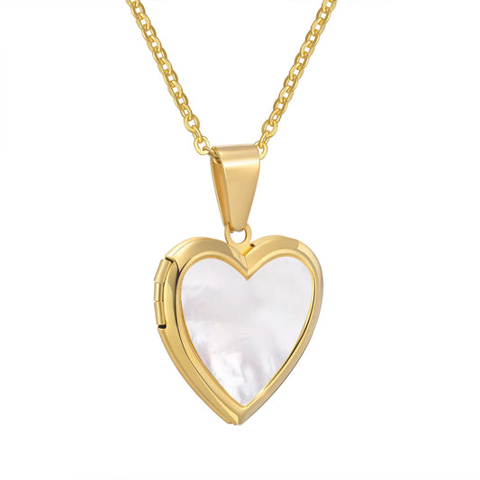 Gold heart-shaped locket with a pearly white interior on a gold chain against a white background