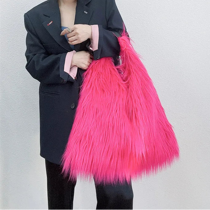 Person holding a bright pink textured bag against a plain background