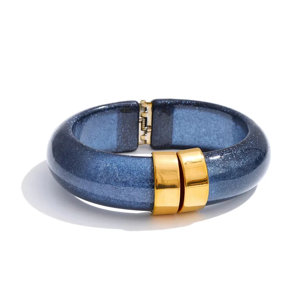 Blue bracelet with gold accents on a white background