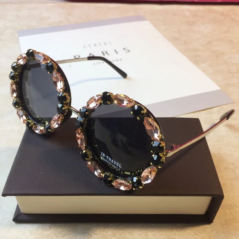 Sunglasses with decorative frame on a book