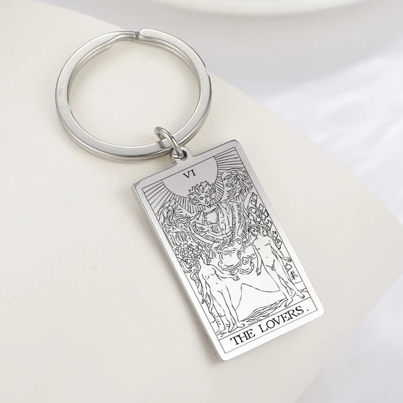Keychain with 'The Lovers' tarot card design on a white surface