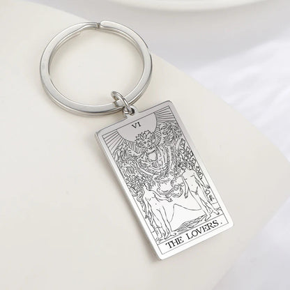 Keychain with 'The Lovers' tarot card design on a white surface