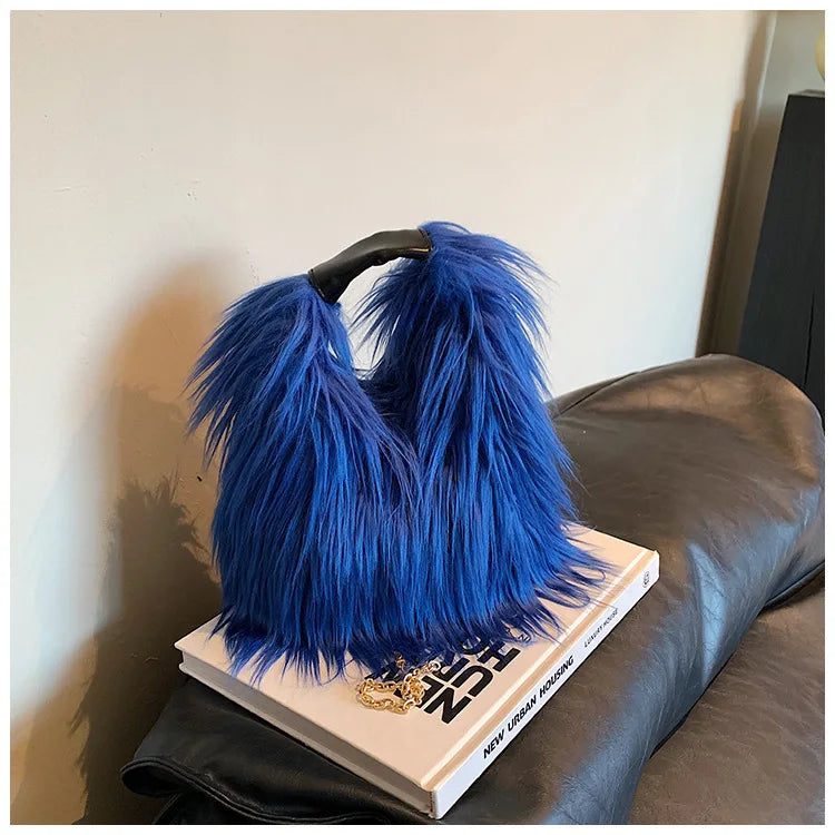 Blue fluffy handbag on a book with a blurred background