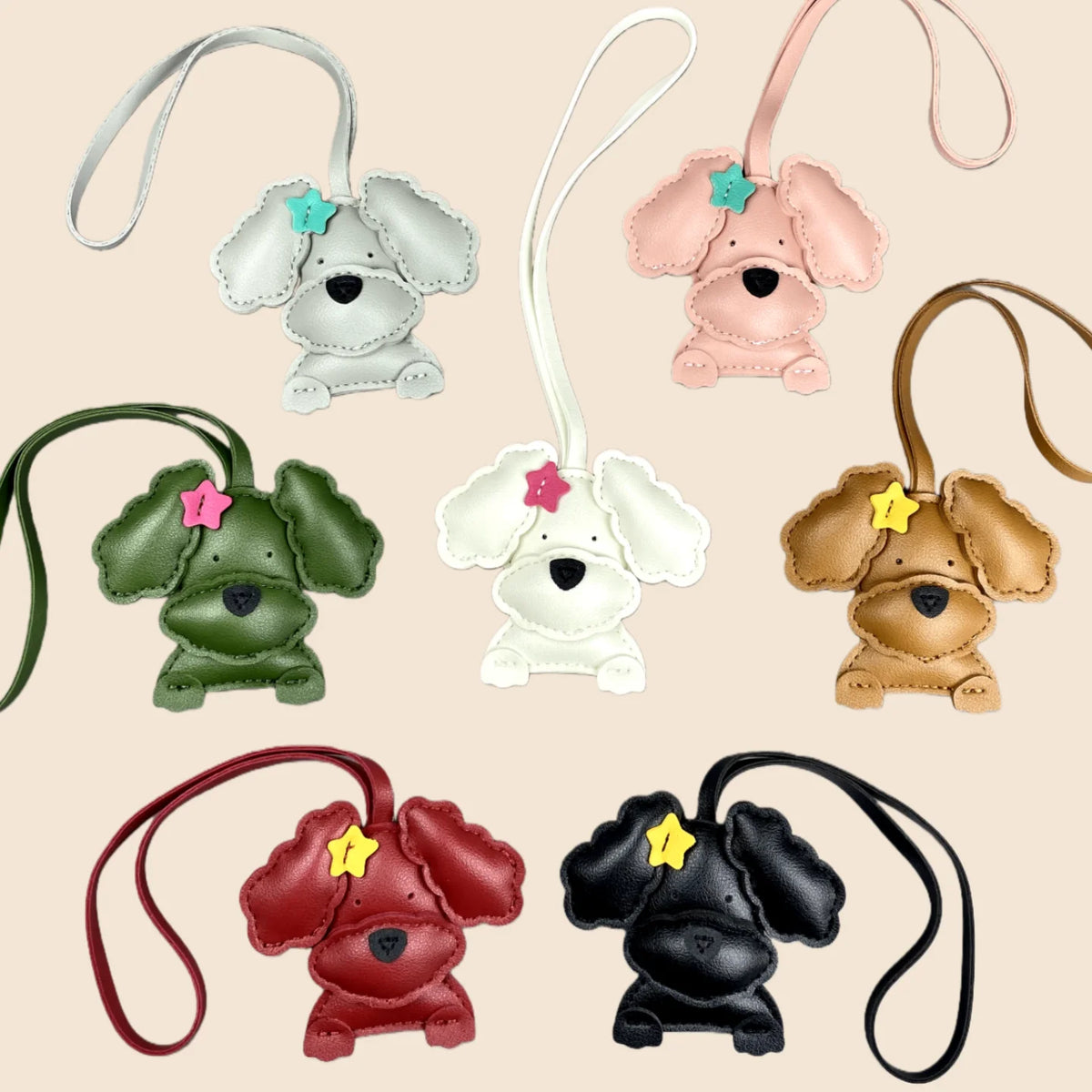 Set of colourful dog-shaped keychains on a beige background