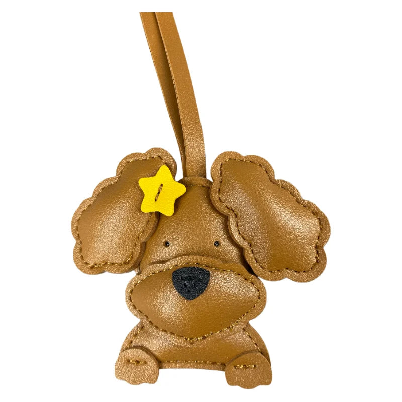 Brown dog-shaped keychain with a yellow bow on a white background
