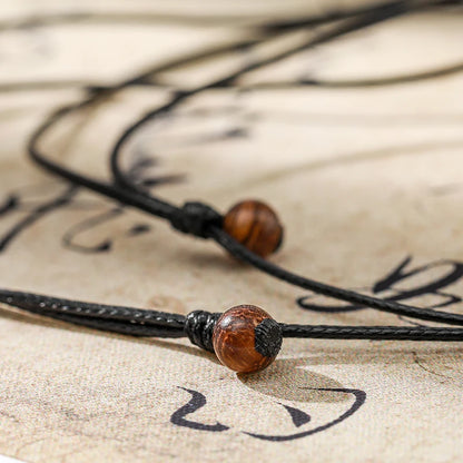 Necklace with brown beads on a textured surface
