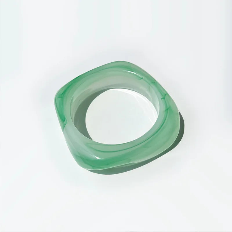 Green bangle on a white background
