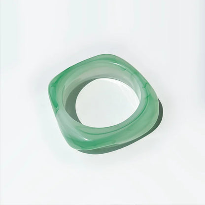 Green bangle on a white background
