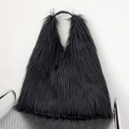 Black shaggy bag on a chair against a white background