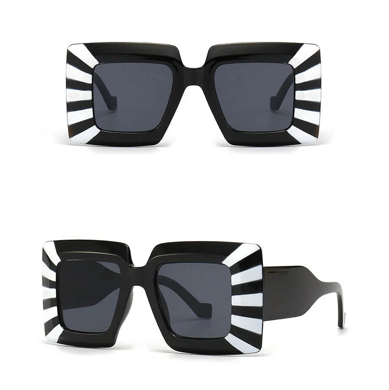 Black and white striped sunglasses with a black frame on a white background