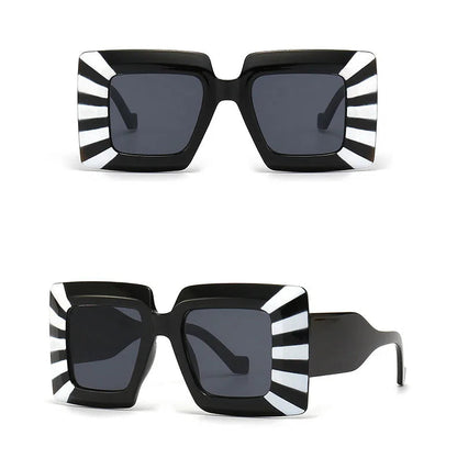 Black and white striped sunglasses with a black frame on a white background