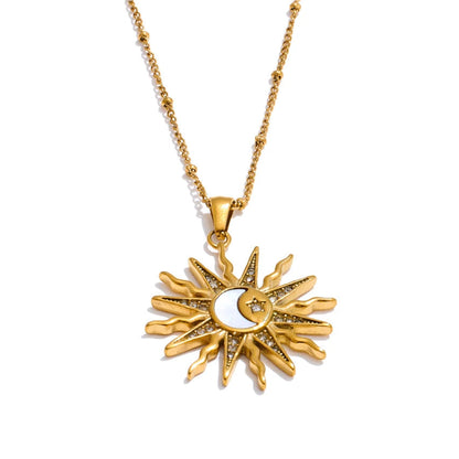 Gold sun and moon pendant necklace on a white background.