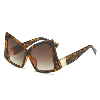 Sunglasses with tortoiseshell frame and gradient lenses on a white background