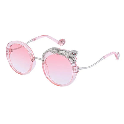 Pink sunglasses with rhinestone accents on a white background