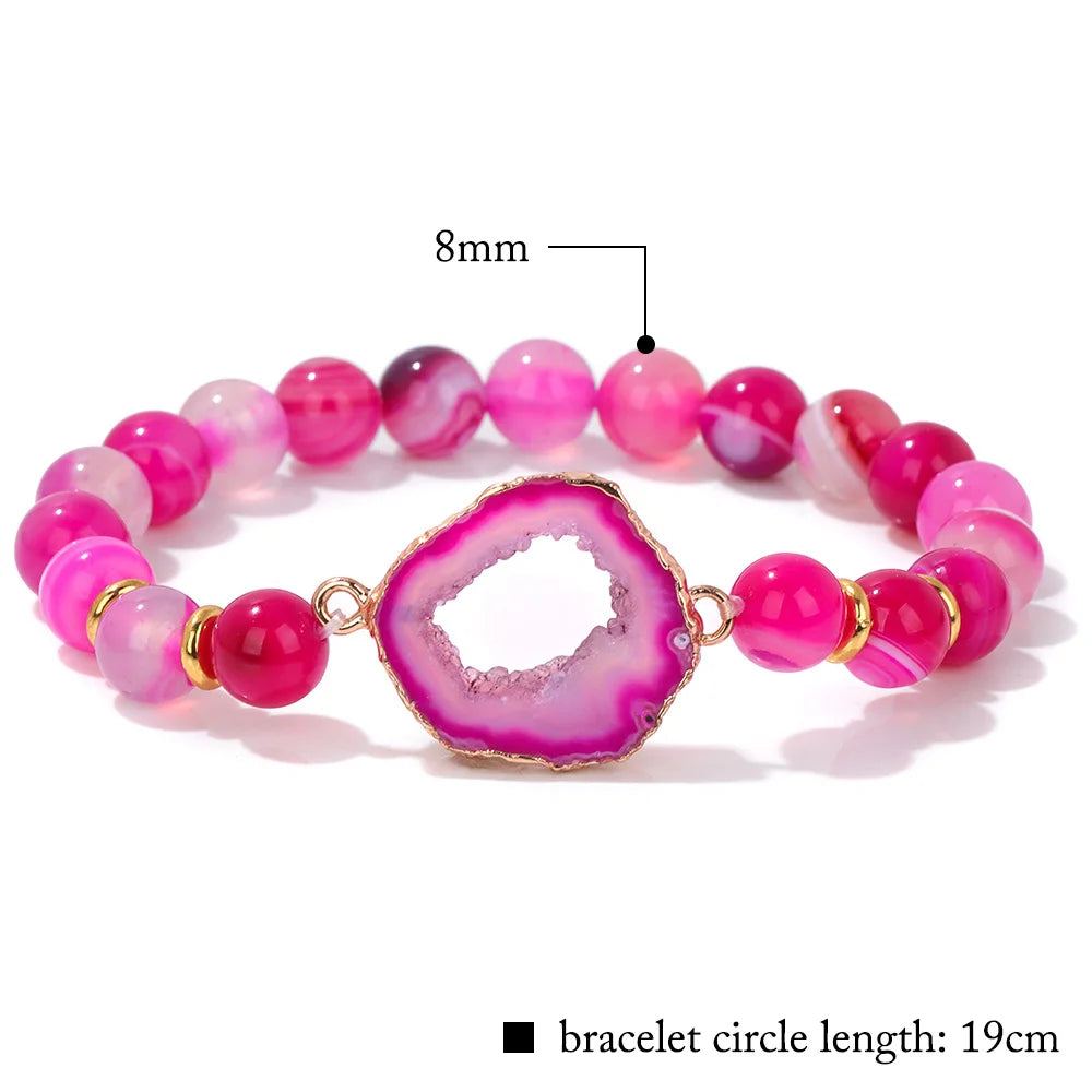 Pink beaded bracelet with a large pink stone, labeled with size and length information.