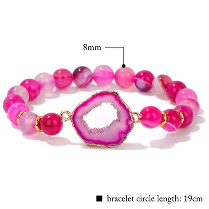 Pink beaded bracelet with a large pink stone, labeled with size and length information.