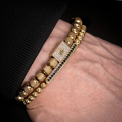 Gold bracelet with a diamond-studded clasp on a wrist against a black background