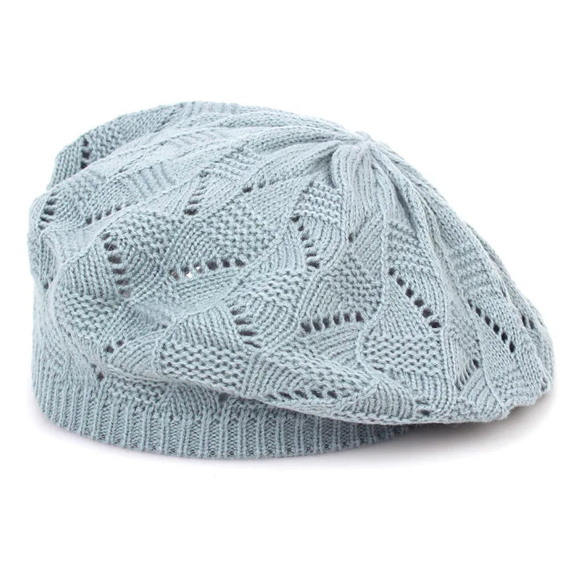 Light blue knitted beret on a white background