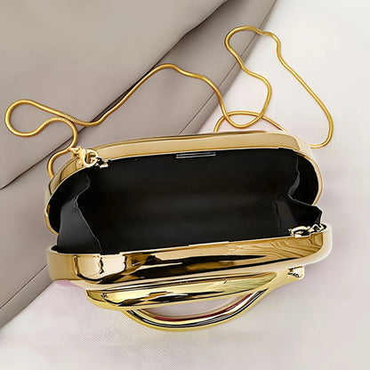 Gold clutch with black lining on a light background