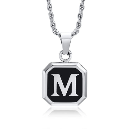 Necklace with a black pendant featuring the letter 'M' on a white background