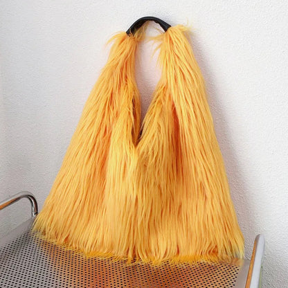 Yellow bag with long handles on a metal trolley against a white wall