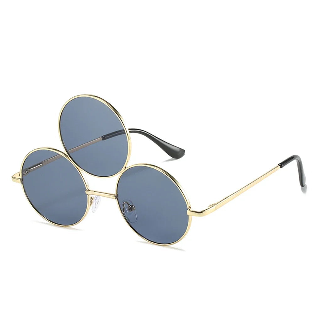 Round sunglasses with gold frame and grey lenses on a white background