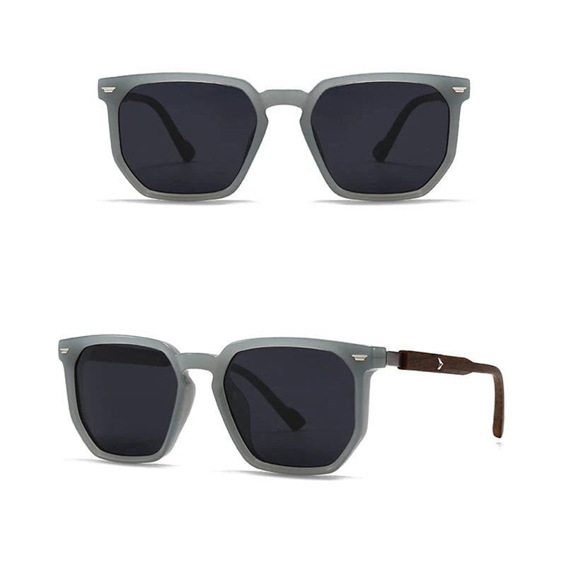 Grey sunglasses with dark lenses on a white background