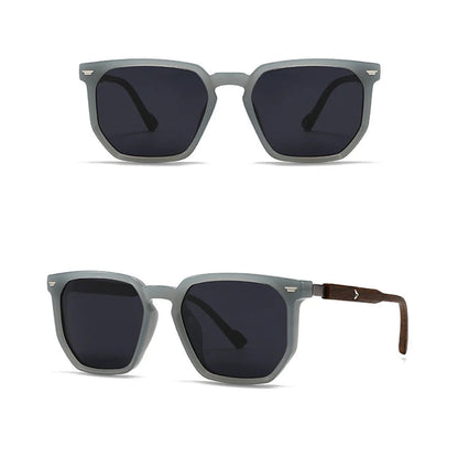 Grey sunglasses with dark lenses on a white background