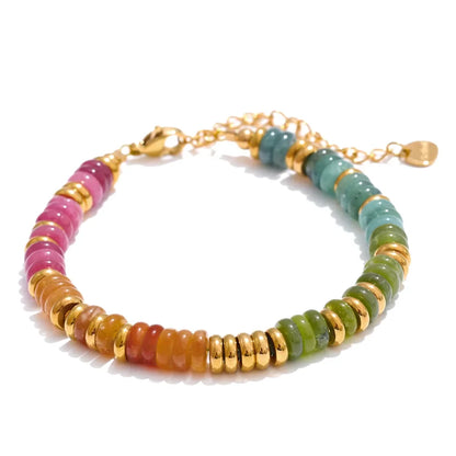 Multicoloured beaded bracelet with gold accents on a white background
