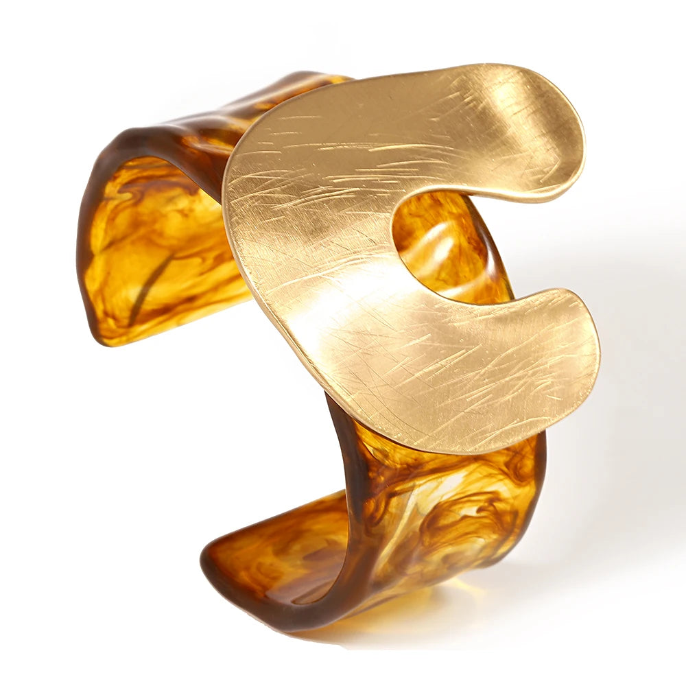 Gold and amber bangle on a white background