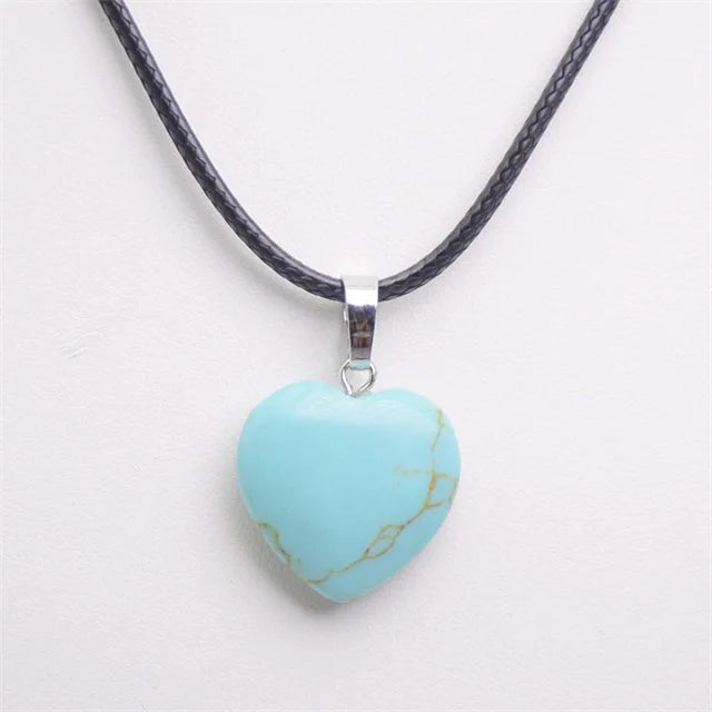 Turquoise heart-shaped pendant on a black cord against a white background