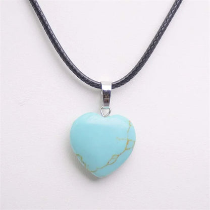 Turquoise heart-shaped pendant on a black cord against a white background