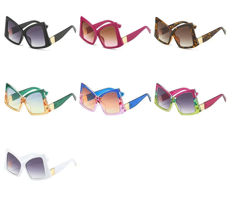 Six pairs of oversized square cat-eye sunglasses shown in different colour options, labeled black, red, leopard, green, blue, and purple on a white background.